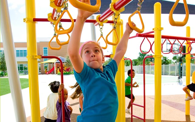 girl on playground monkey-bars